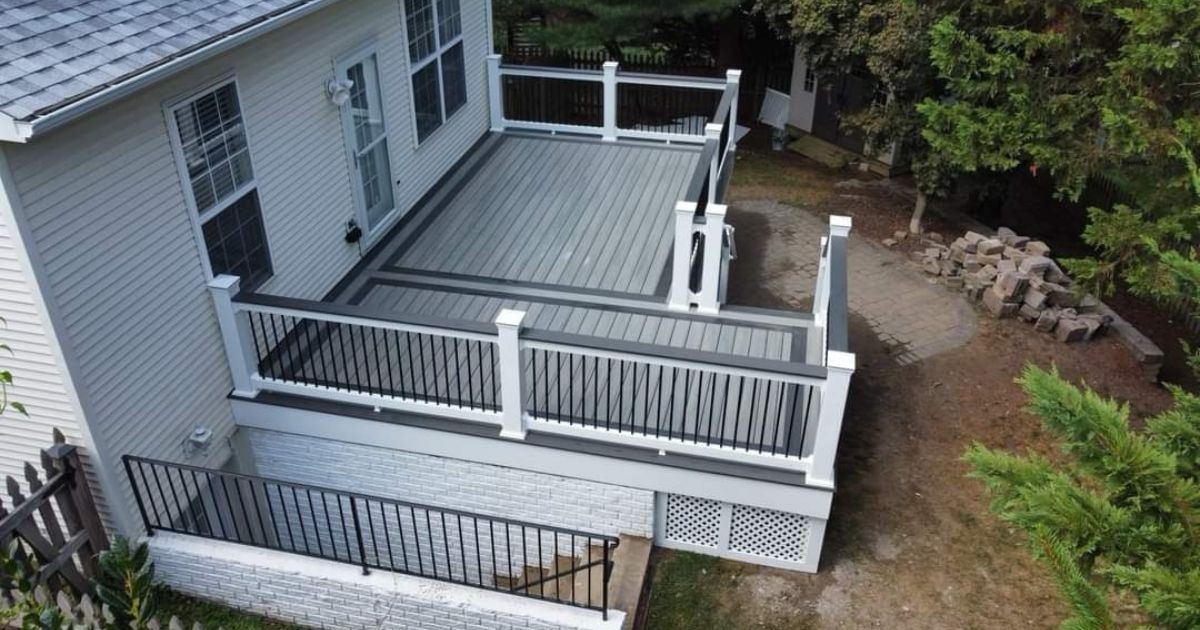Pressure-treated wood deck built in a Lancaster, PA backyard with stairs and custom railings.