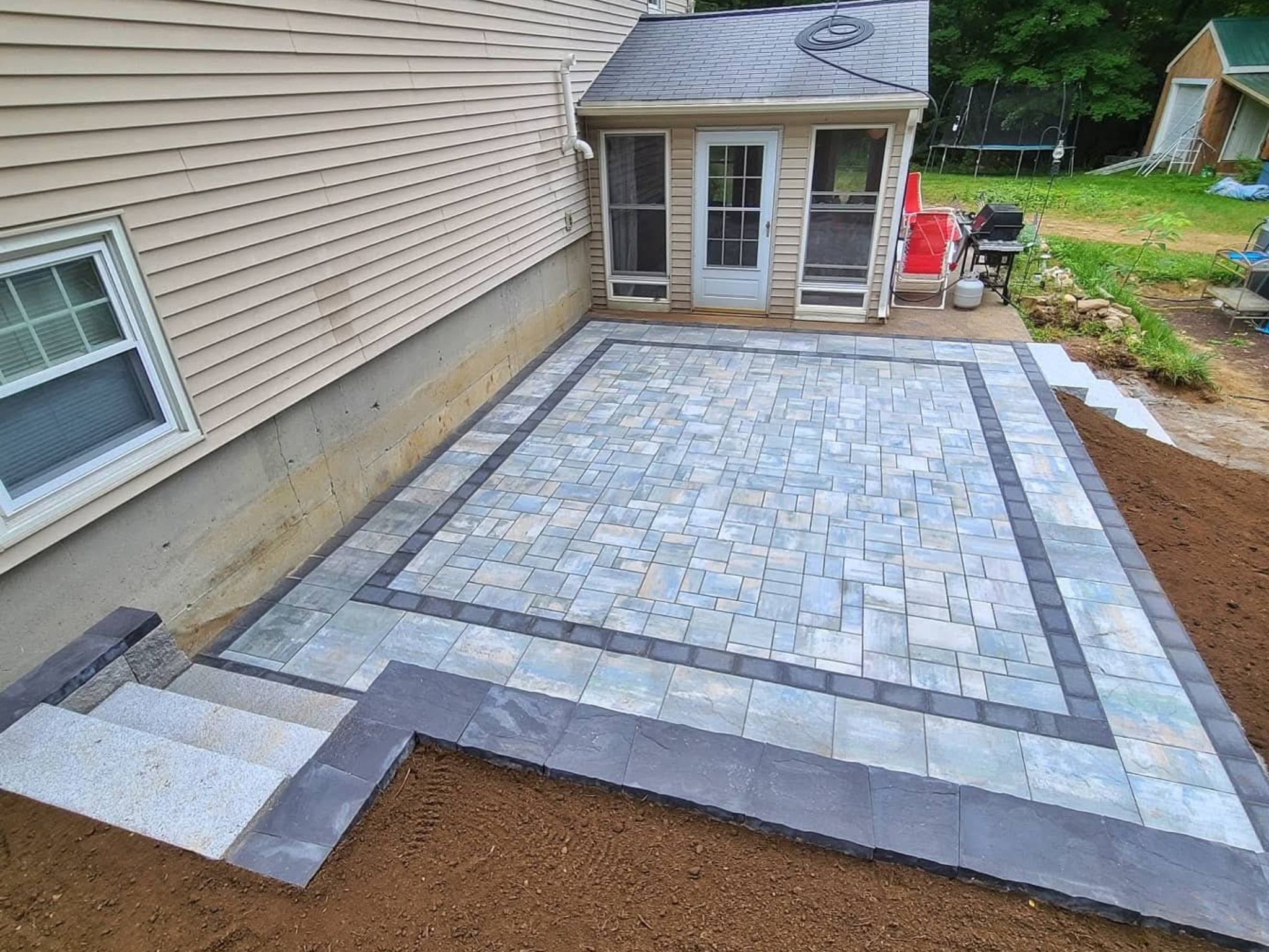 Small backyard paver patio with space for chairs and a coffee table in Lancaster, PA